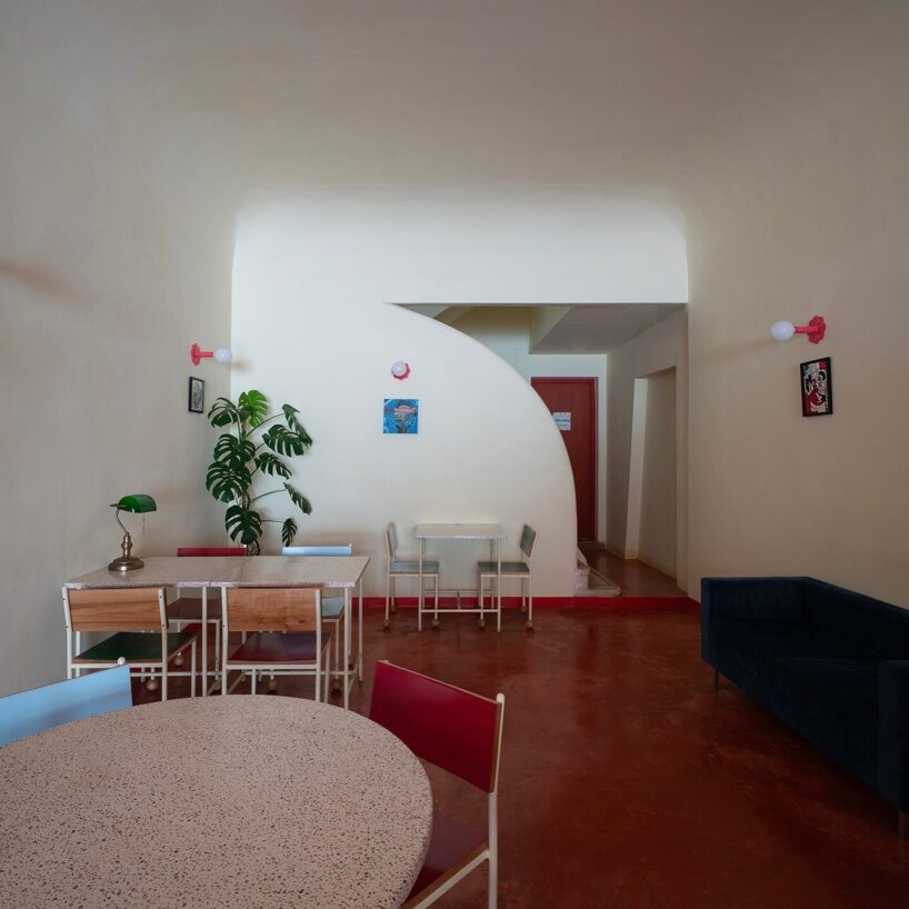 caf&eacute;&rsquo;s red facade carves welcoming hand-shaped entrance in vietnam