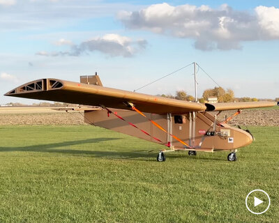 cardboard airplane with wooden wings takes flight using remote control