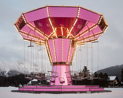 carsten höller's pink mirrored carousel slows time on the ice rink of the kulm hotel st. moritz