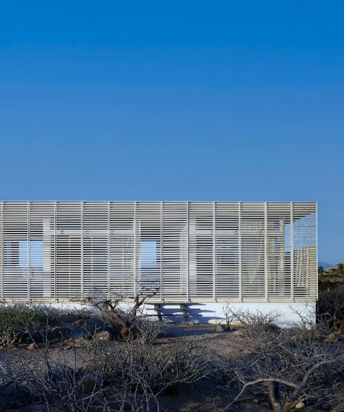 white louvers craft perforated facade filtering daylight within casa nada’s interiors in mexico