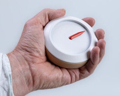 wooden compass with single red arrow leads people with dementia to their homes
