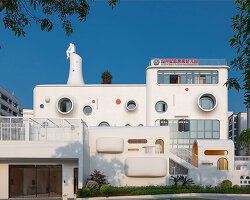 dika design shapes playful interstellar kindergarten crowned by astronaut sculpture