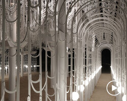 cloud-like white canopy of hanging vines emerges from abu dhabi’s arid landscape