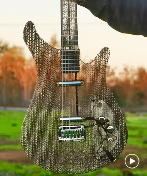 electric guitar made of air and recycled cardboard plays as functional musical instrument