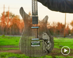 electric guitar made of air and recycled cardboard plays as functional musical instrument