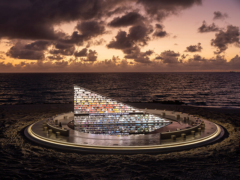 es devlin's triangular bookshelf rotates within a mirrored pool for miami art week 2025