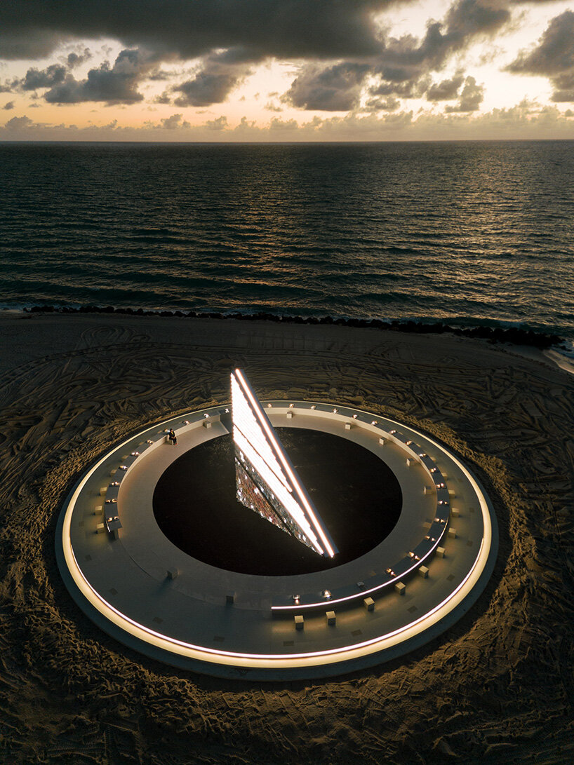 es devlin's triangular bookshelf rotates within a mirrored pool for miami art week 2025