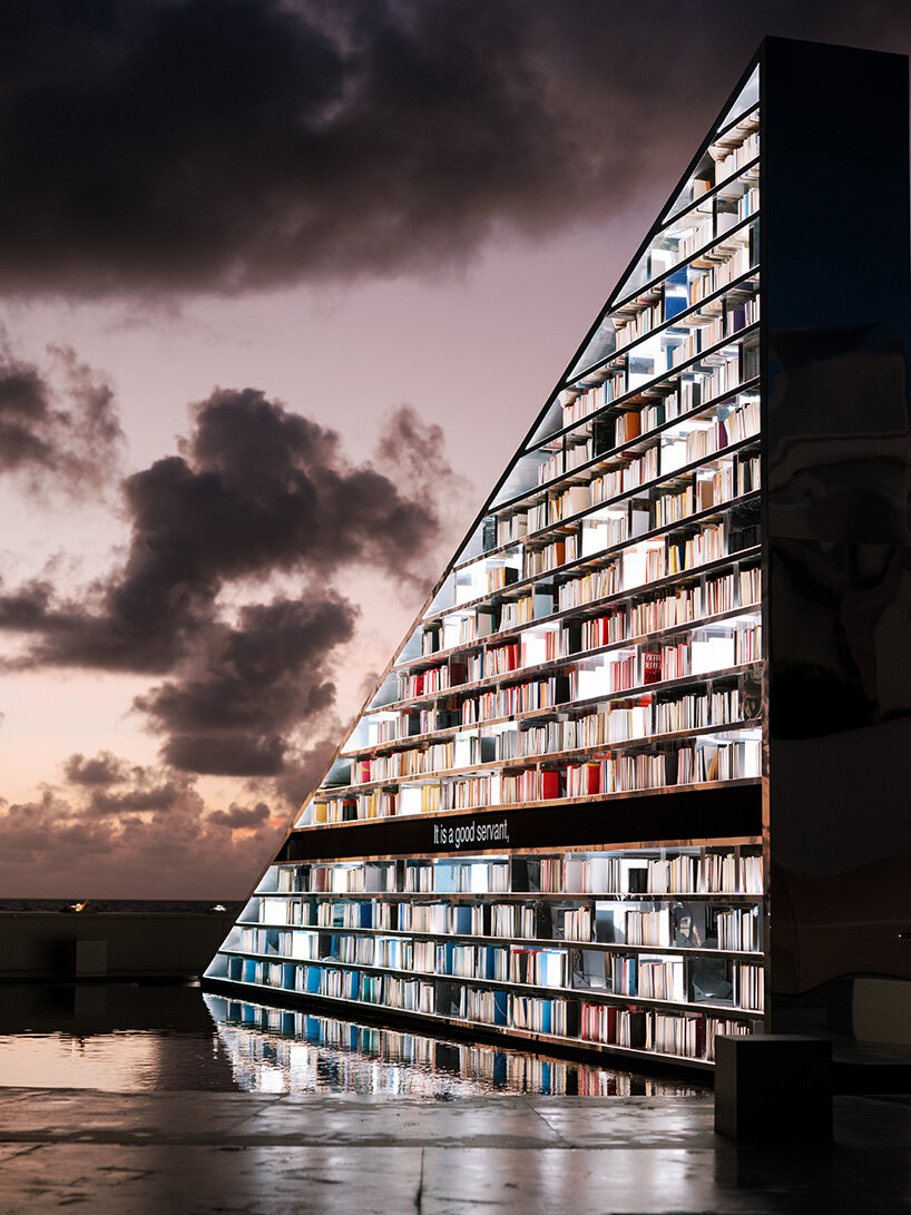 es devlin's triangular bookshelf rotates within a mirrored pool for miami art week 2025