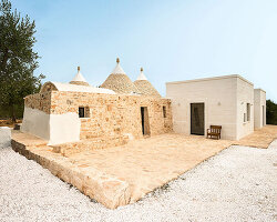 three traditional stone-domed trulli fuse with contemporary residence by studio8 in italy