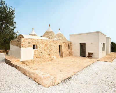 three traditional stone-domed trulli fuse with contemporary residence by studio8 in italy