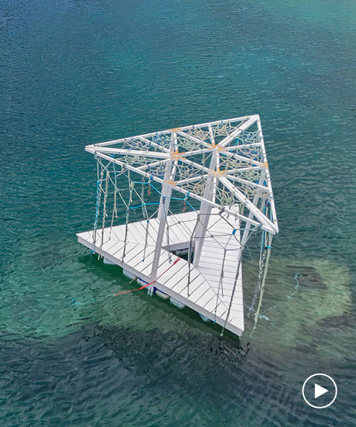 triangular wooden pavilion floats on reused plastic gallons along croatia’s coasts