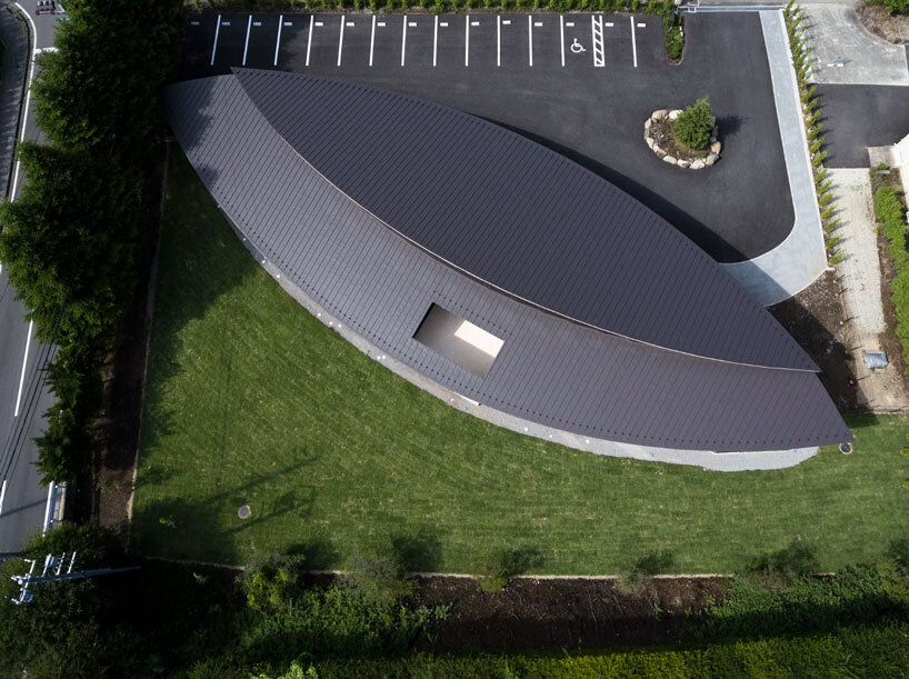 twin leaf-shaped roofs unfold atop nursery school by NIKKEN SEKKEI in japan