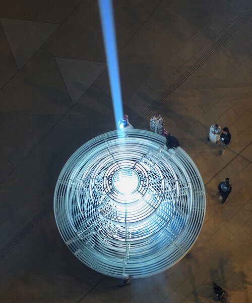 reflective pyramidal monument emits sky-tracing beam of white light in saudi arabia