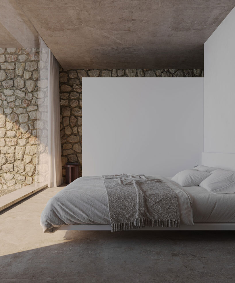 clad in timber, stone house by SHOVK perches over rocky oceanfront slope in portugal