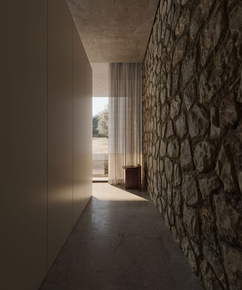 clad in timber, stone house by SHOVK perches over rocky oceanfront slope in portugal