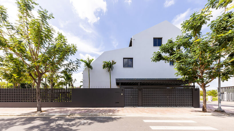 tent house expands under overlapping angular roof planes in vietnam