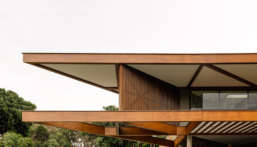 TETRO's lakeside residence in brazil vanishes into the horizon beneath triangular timber roof