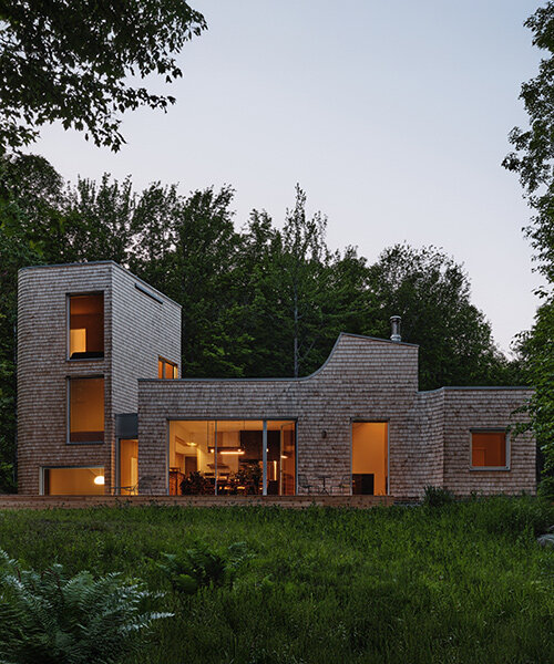 cedar shingle-wrapped 'waterhouse' dots a forest clearing in quebec