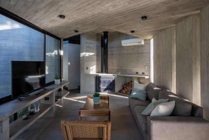 forest home by besonías almeida fits organically around native trees on argentinian coast