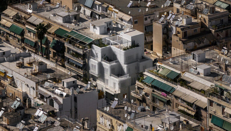 arid layers lightweight volumes atop 1950s building in athens