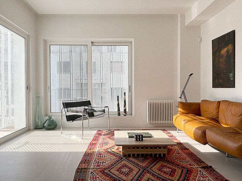 layered lightweight volumes by arid extend 1950s building in patissia, athens