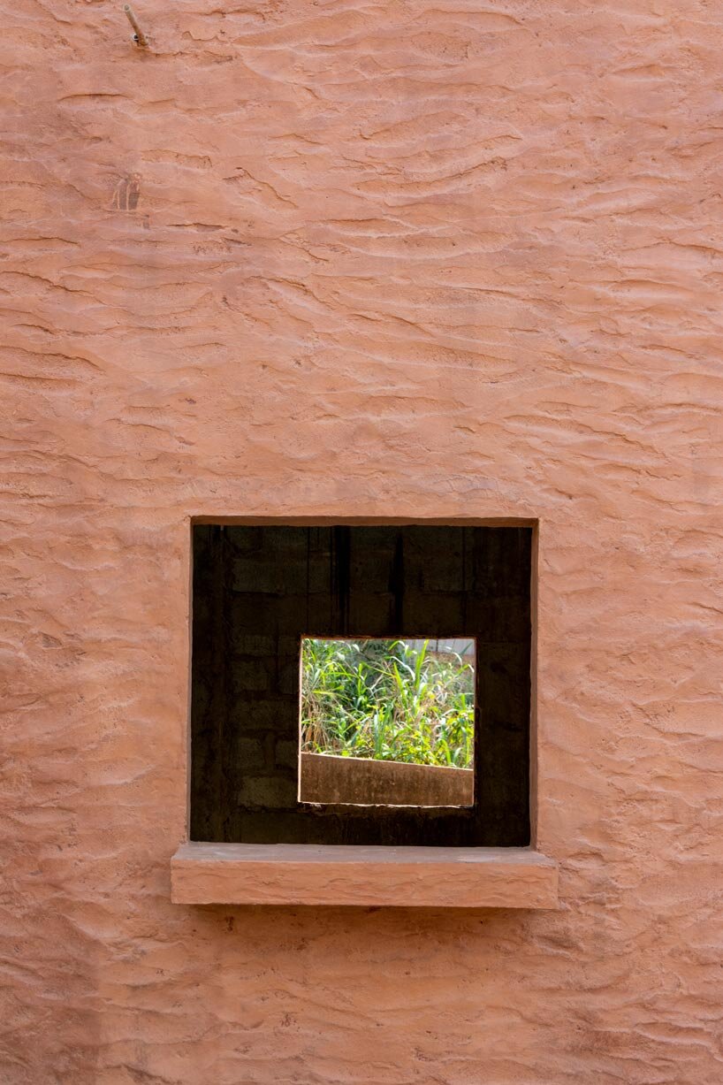 clay-pigmented monolithic villas emerge from ghana&rsquo;s red earth landscape