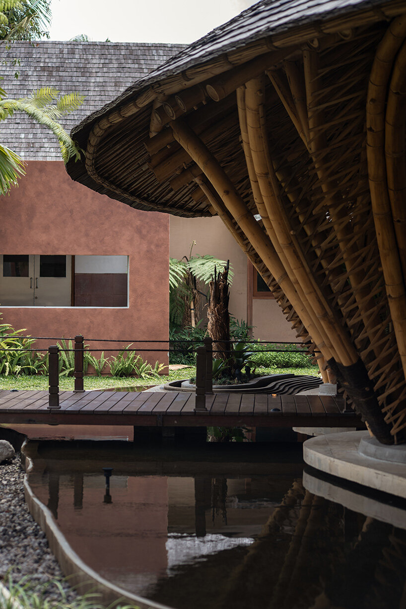 circular bamboo roof collects rainwater at balinese restaurant by pablo luna studio