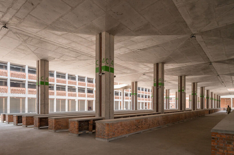 concrete canopies and porous brick walls form central market redevelopment in congo