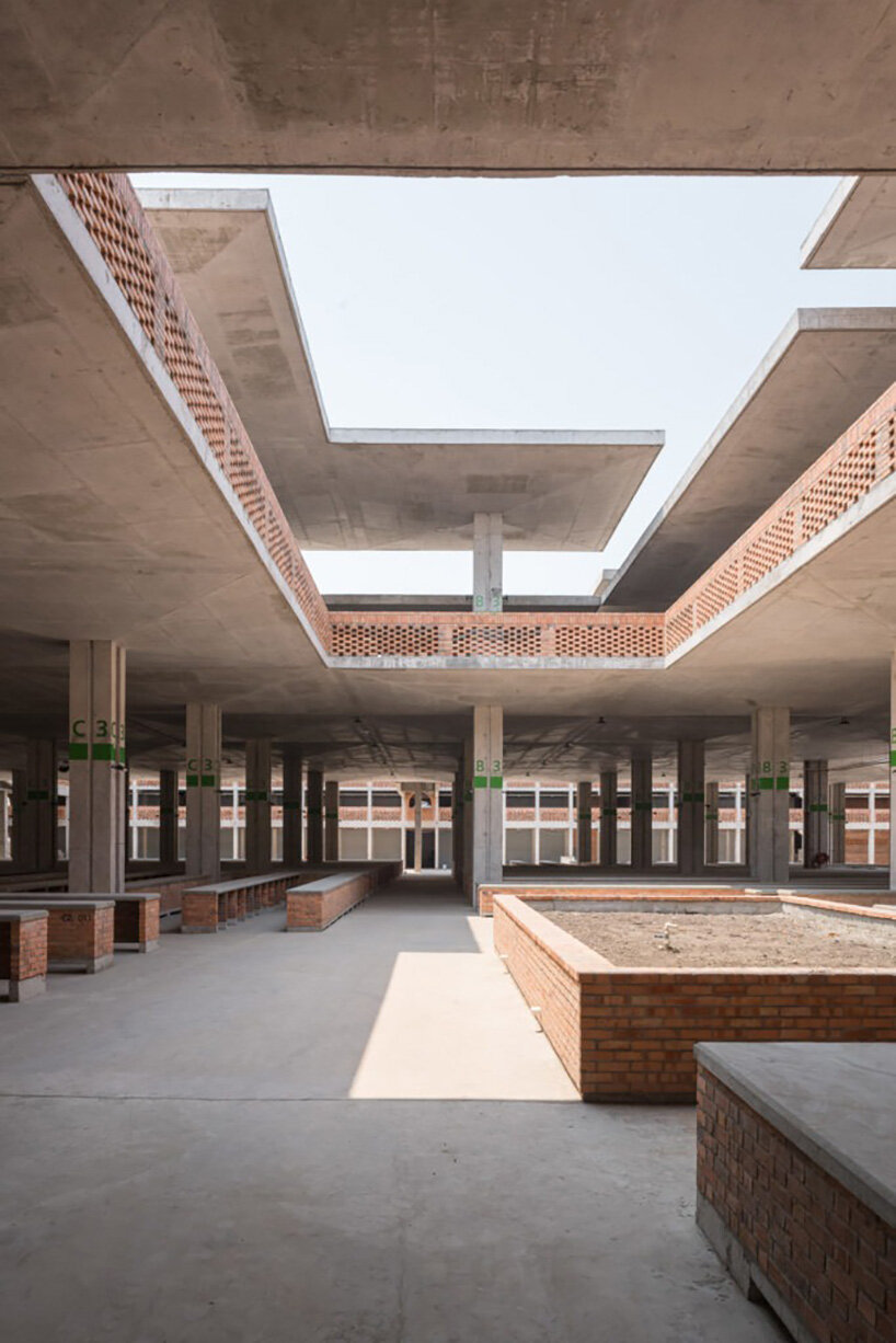concrete canopies and porous brick walls form central market redevelopment in congo
