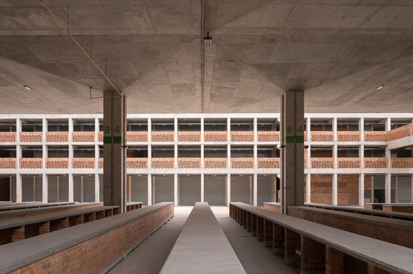 concrete canopies and porous brick walls form central market redevelopment in congo