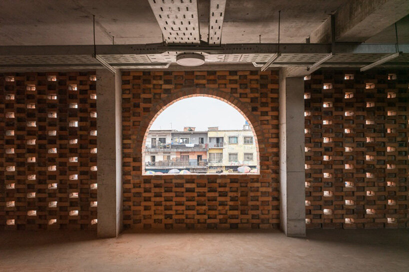 concrete canopies and porous brick walls form central market redevelopment in congo