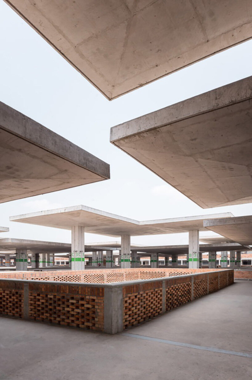 concrete canopies and porous brick walls form central market redevelopment in congo