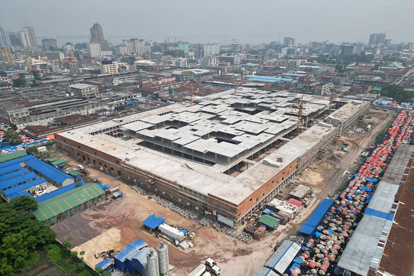 concrete canopies and porous brick walls form central market redevelopment in congo