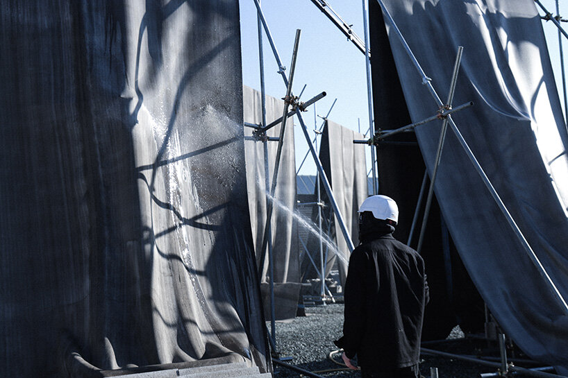 concrete canvas wraps 18 scaffolding monoliths for monumental installation in florence