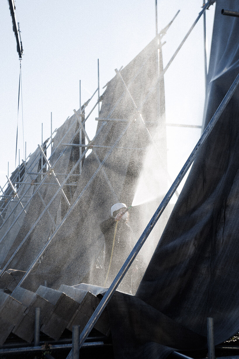 concrete canvas wraps 18 scaffolding monoliths for monumental installation in florence