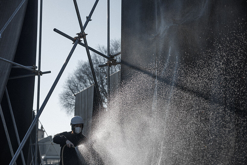 concrete canvas wraps 18 scaffolding monoliths for monumental installation in florence