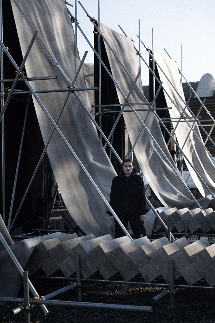 concrete canvas wraps 18 scaffolding monoliths for monumental installation in florence