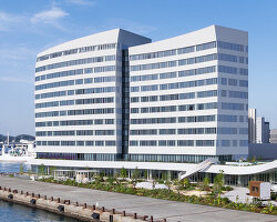 curved twin volumes shape the risonare shimonoseki hotel along japan's kanmon strait