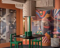 patterned tiles extend from curved walls to furniture in layered retail exhibition booth