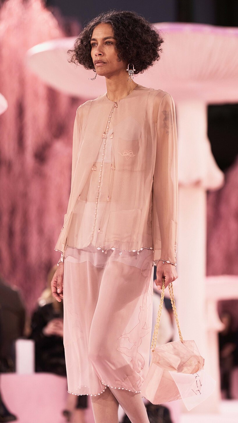 giant mushrooms populate dreamlike forest set inside the grand palais for chanel show