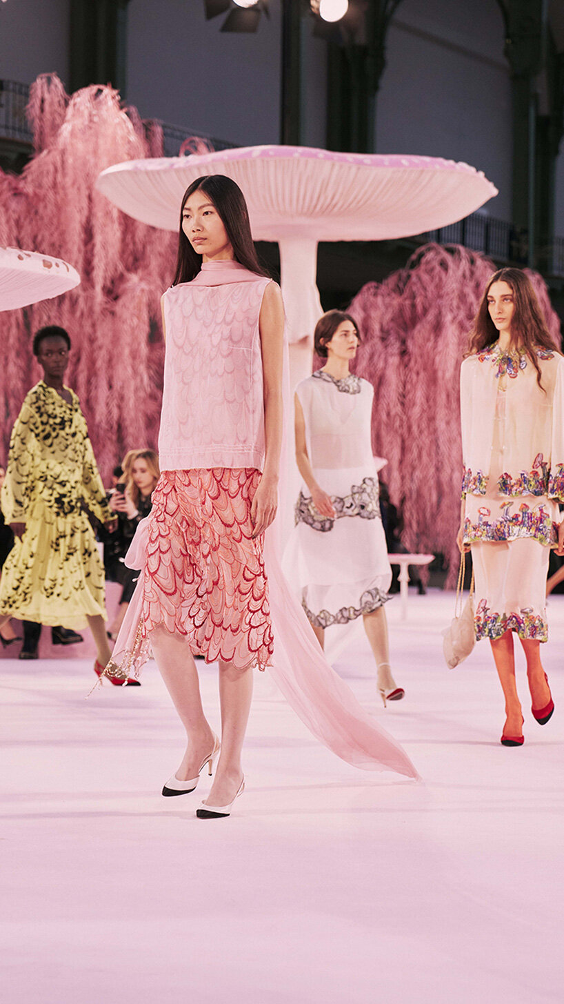 giant mushrooms populate dreamlike forest set inside the grand palais for chanel show
