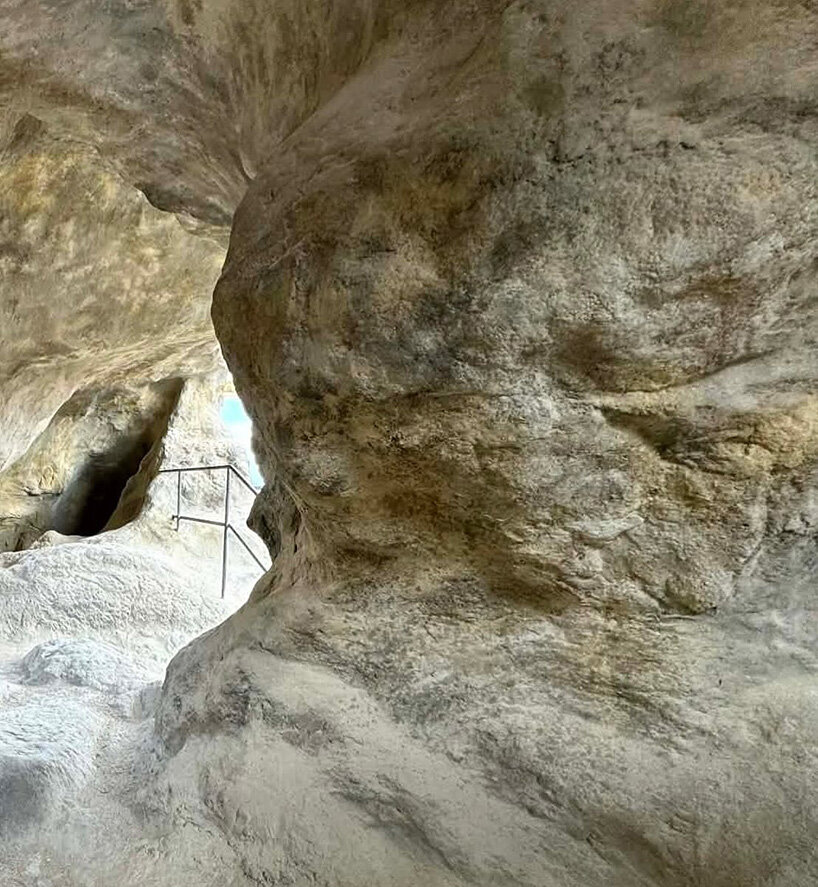 irregular voids reveal cave-like, geological interior inside japanese residence