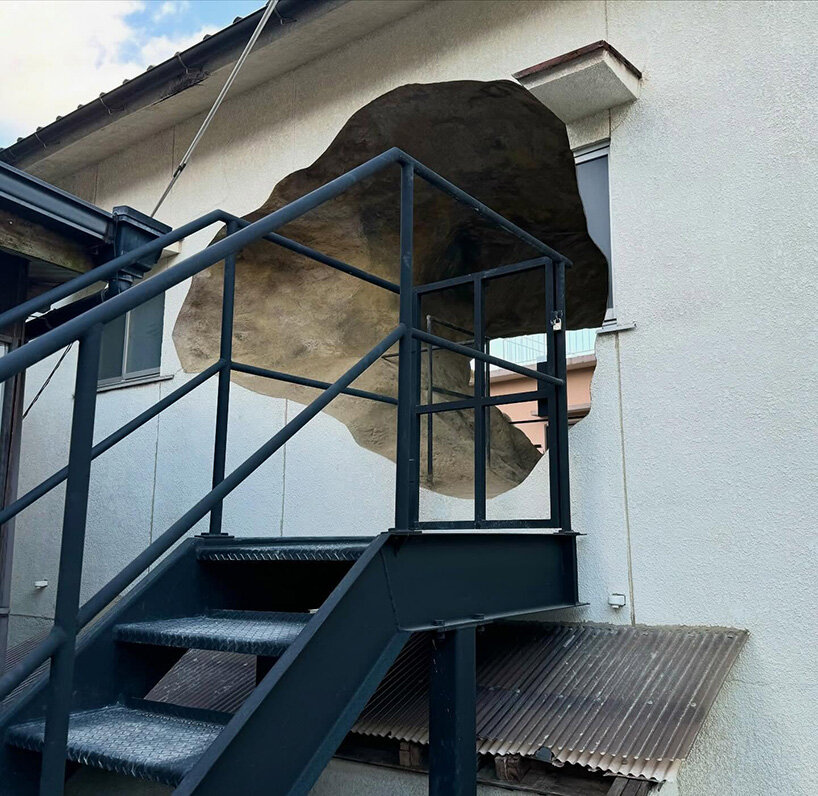 irregular voids carve cave-like, geological interior inside japanese residence