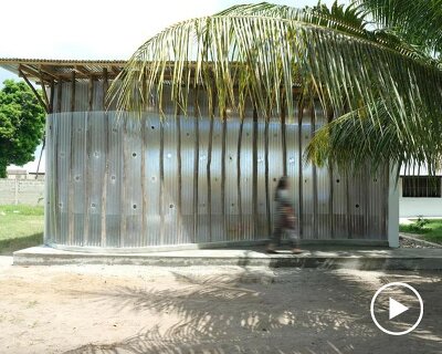 perforated corrugated panels regulate light and ventilation at library in tanzania