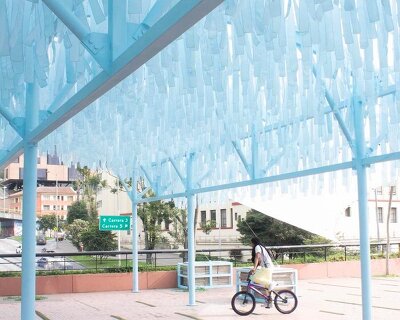 blue fabric fragments dance with the wind on modular cultural pavilion in colombia
