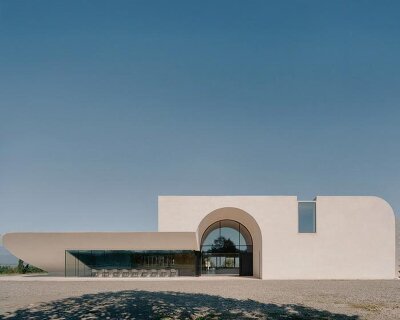 arches and voids carve winery’s monolithic white facade in georgia