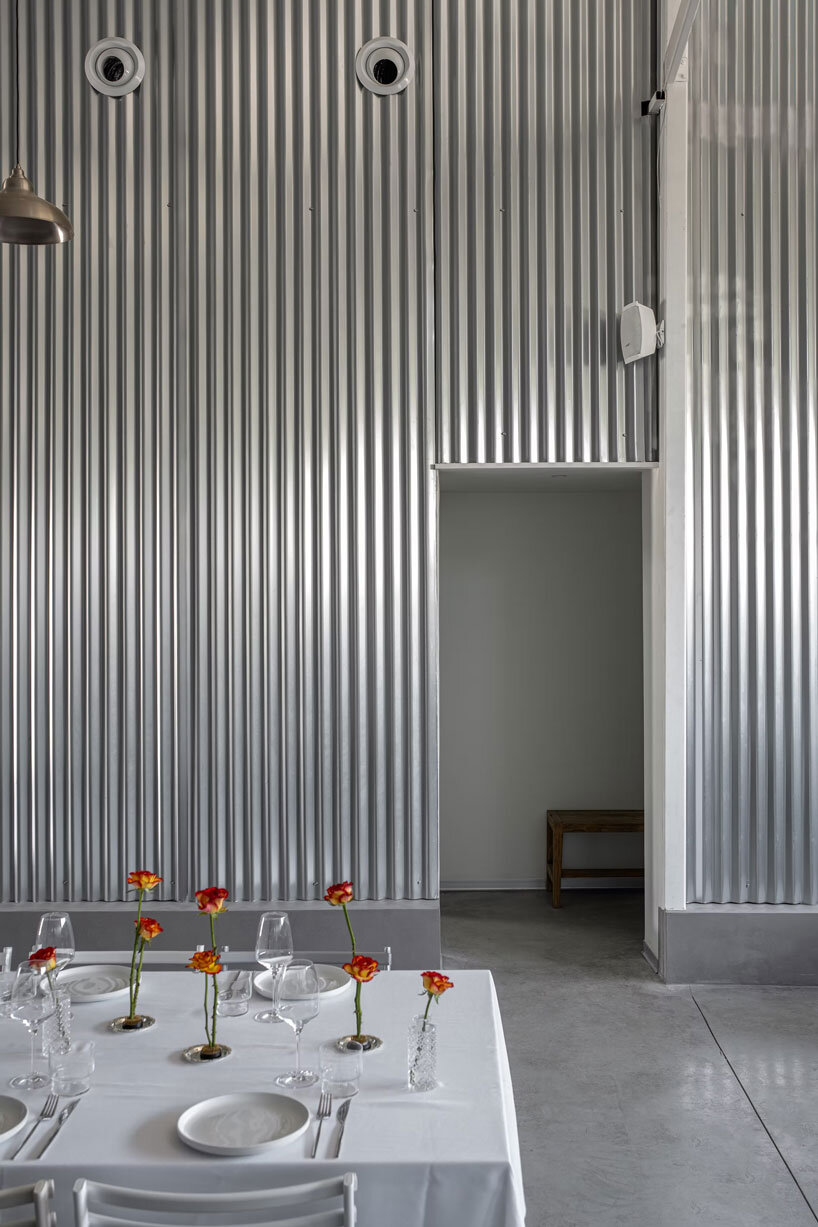 corrugated metal interiors reinvent vegetable storage fridge into industrial hospitality space