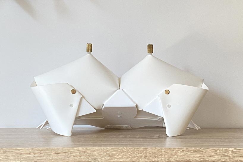 La lámpara de cangrejo de origami se pliega y se convierte en una mesita de noche que emite un brillo suave.
