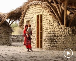 vaulted palm canopy shields dry stone guesthouse cluster in southeastern iran