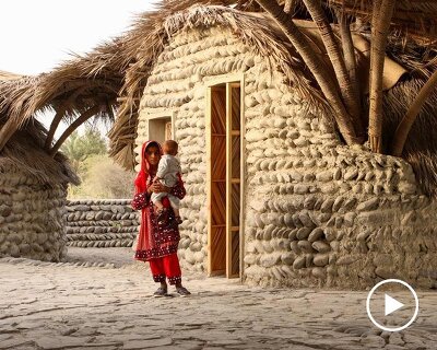 vaulted palm canopy shields dry stone guesthouse cluster in southeastern iran